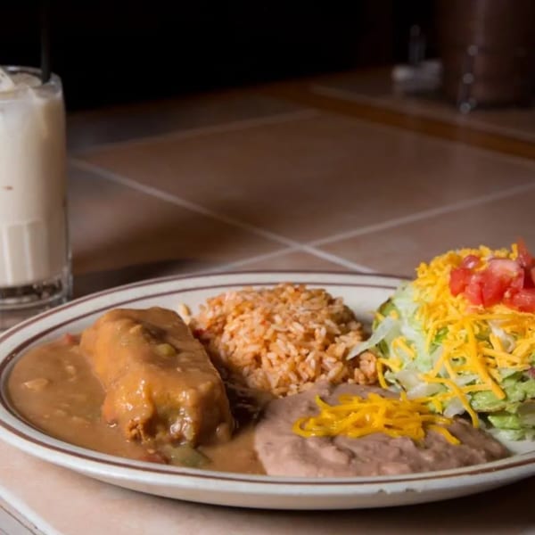 A Moose Hill Cantina Mexican combo plate with a burrito, rice, beans, and salad.