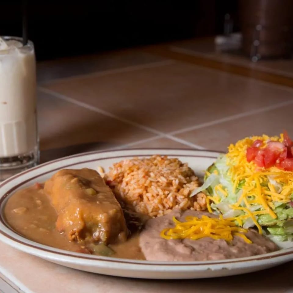 A Moose Hill Cantina Mexican combo plate with a burrito, rice, beans, and salad.